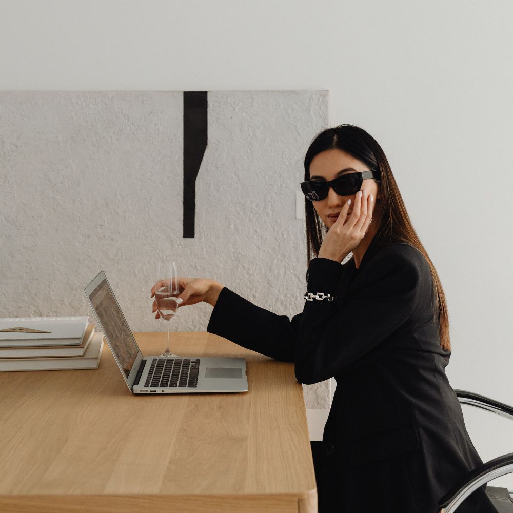 Two women posing for a photo at a desk. Tactical Marketing with 4Zero Marketing